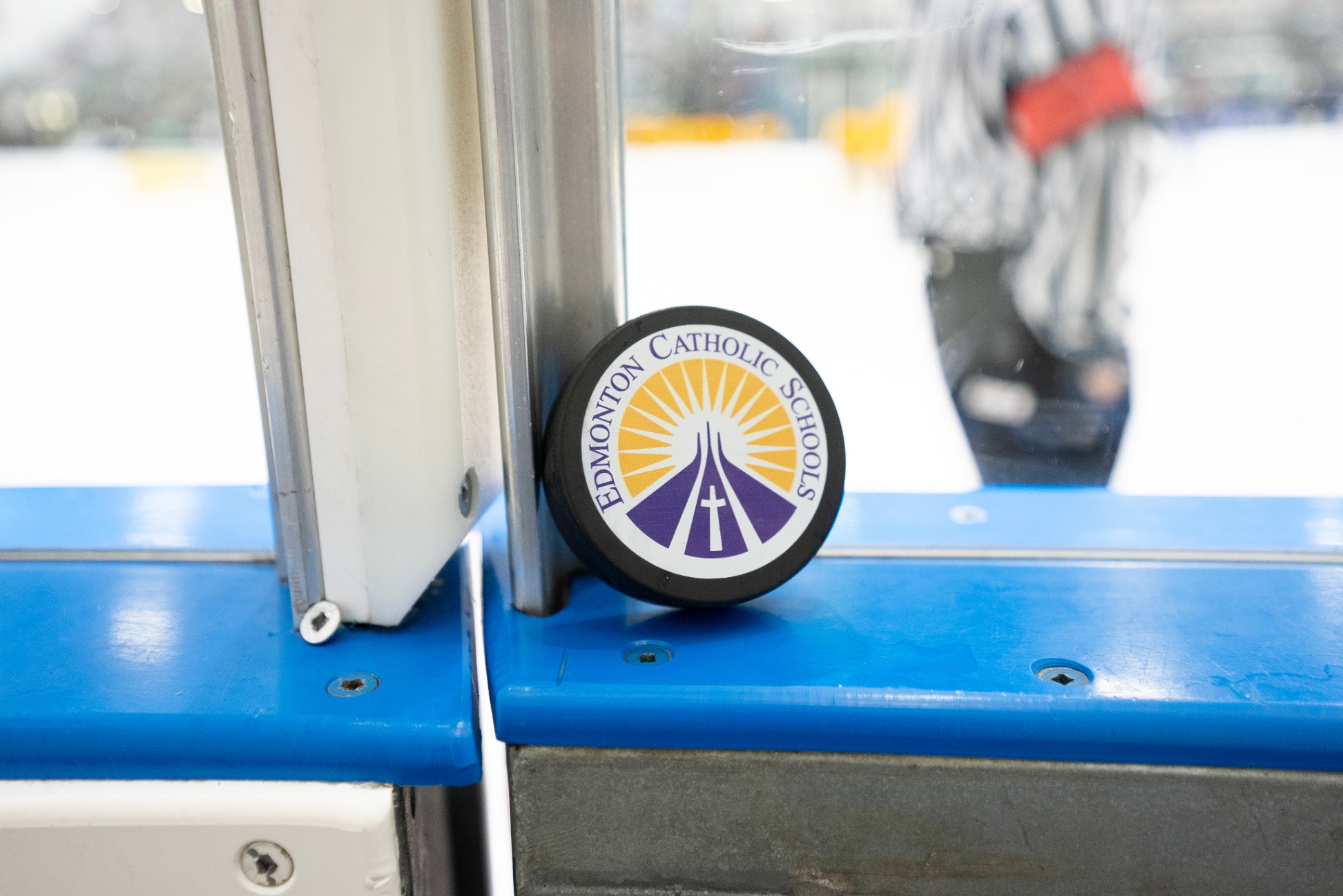 Hockey puck resting against the glas