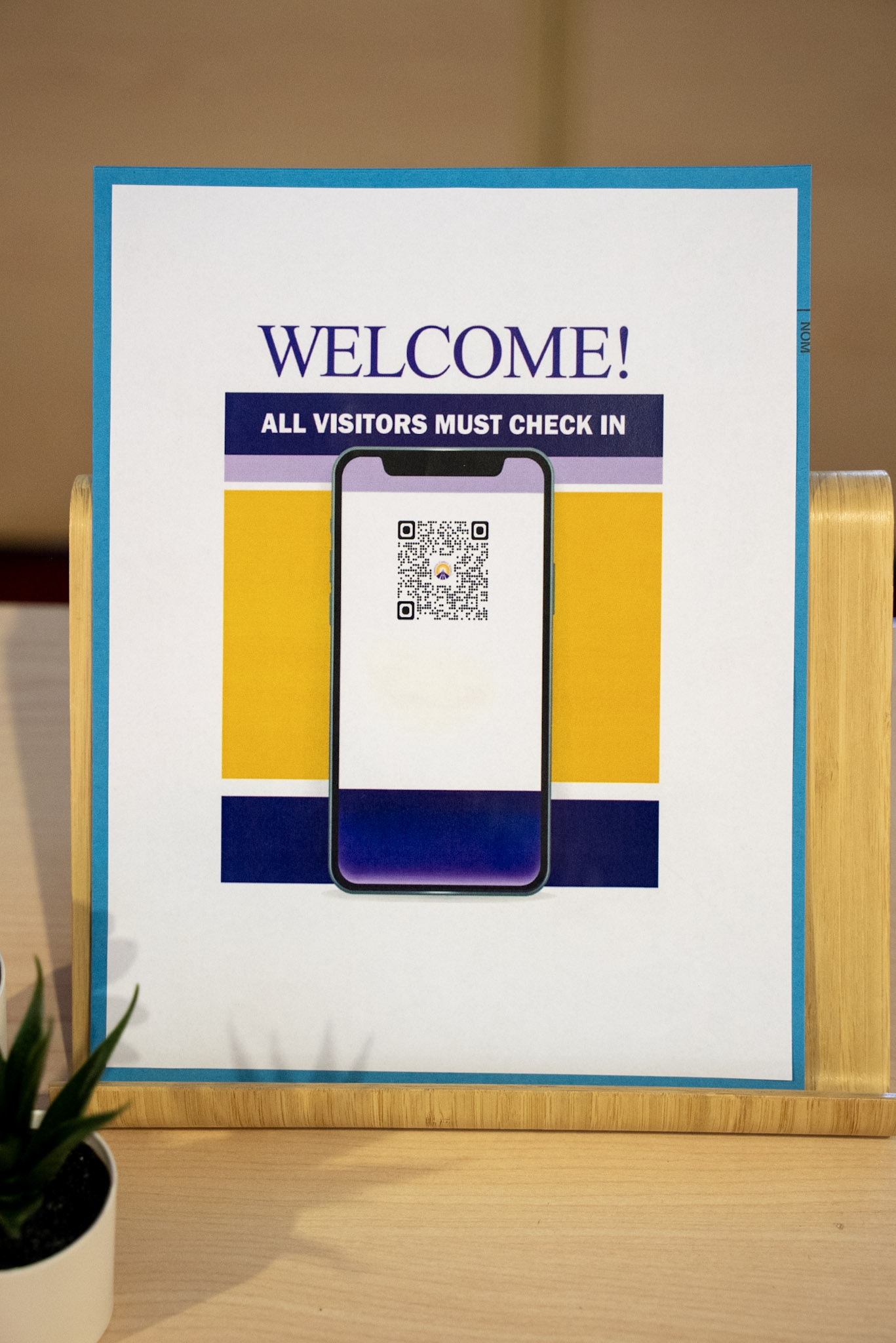 A poster showing QR code for digital sign-in process