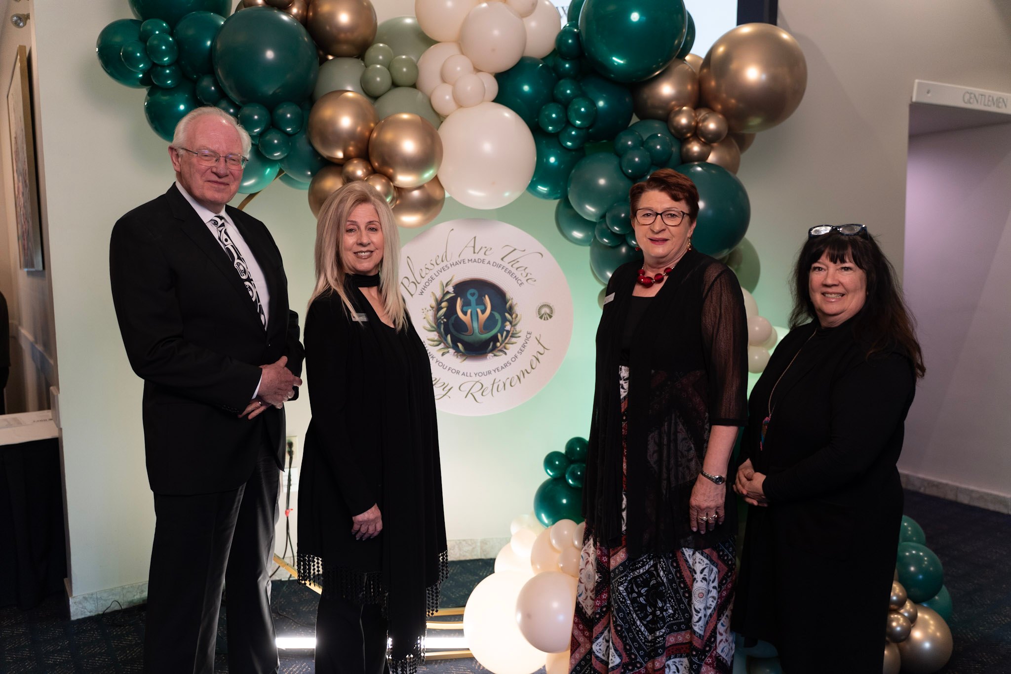 Trustees Harris, Palazzo, Mutala, and Turchansky standing in front of balloons at the retirement gala. 